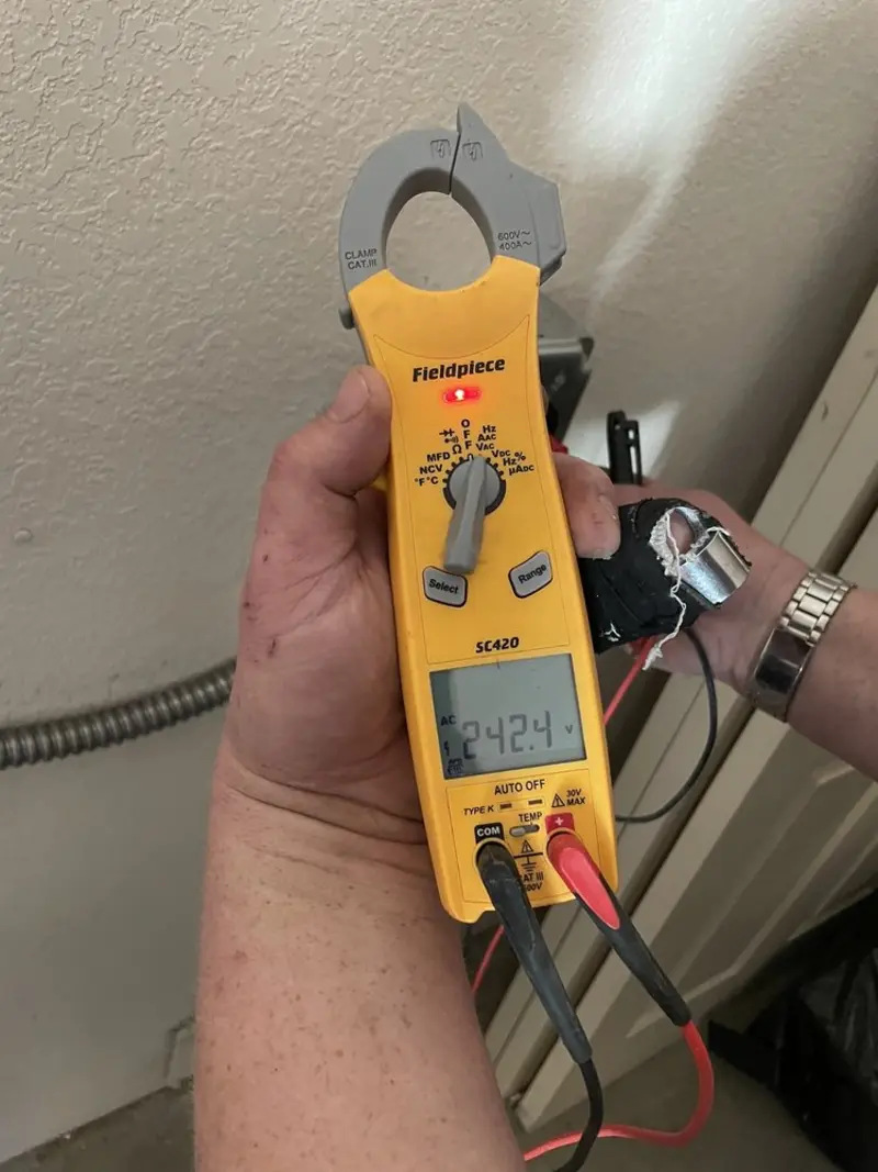 Voltage testing with clamp meter during Whole House Surge Protector in Oostburg